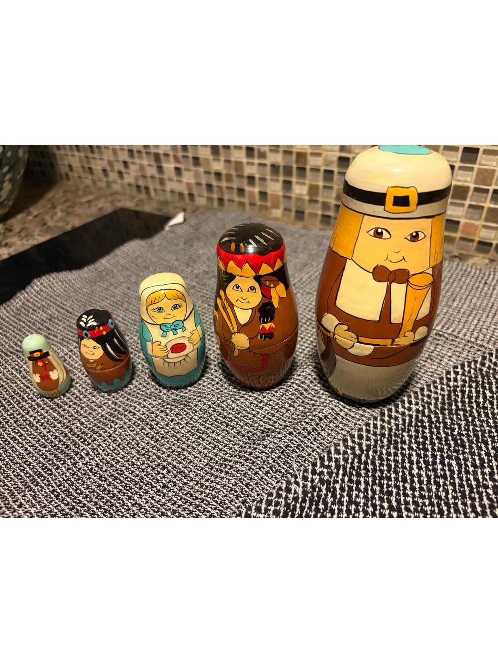 A 1993 Lillian Vernon hand-painted Thanksgiving wooden nesting doll set.
